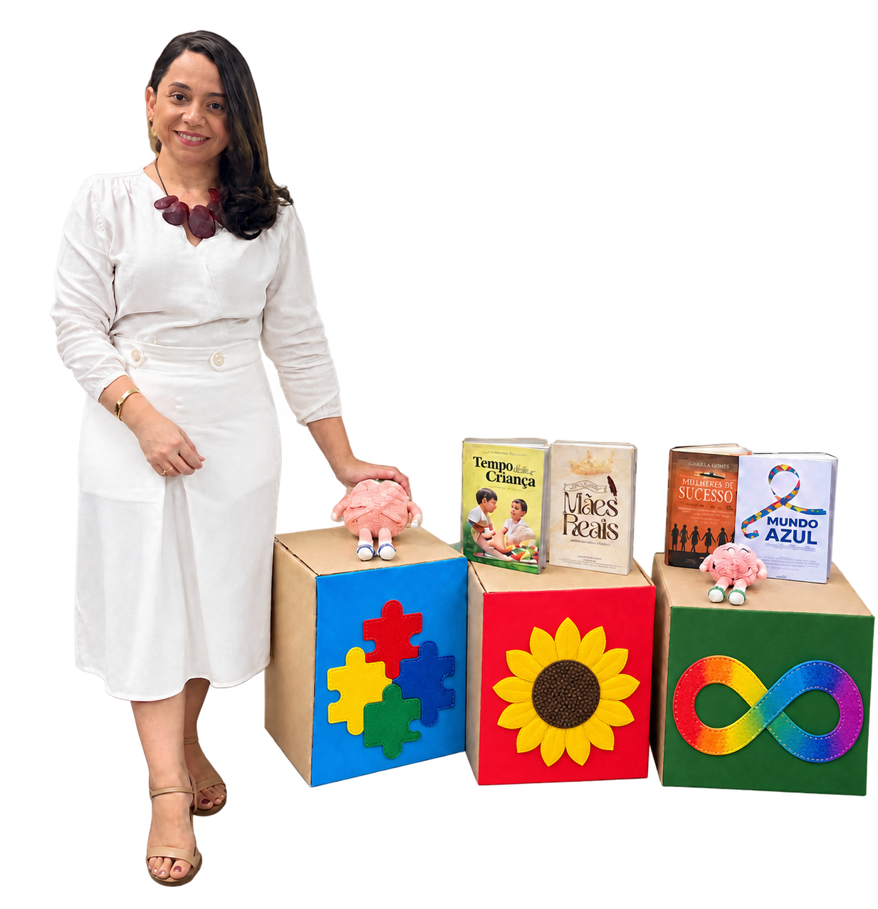 Anna Patrícia junto a livros e símbolos do autismo, das deficiências ocultas e da neurodiversidade